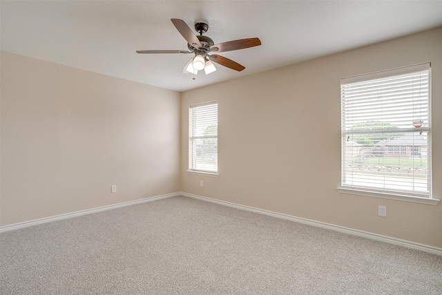 carpeted empty room with baseboards and ceiling fan