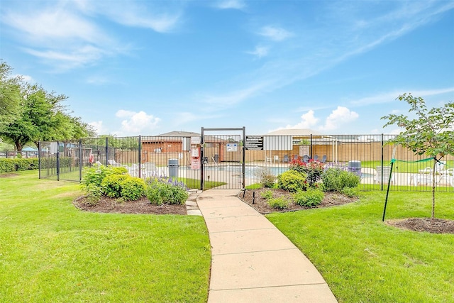 surrounding community featuring a gate, fence, and a yard