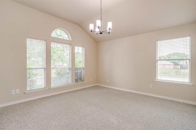spare room featuring carpet floors, baseboards, a chandelier, and vaulted ceiling