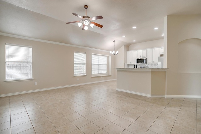unfurnished living room with ornamental molding, ceiling fan with notable chandelier, and light tile patterned flooring