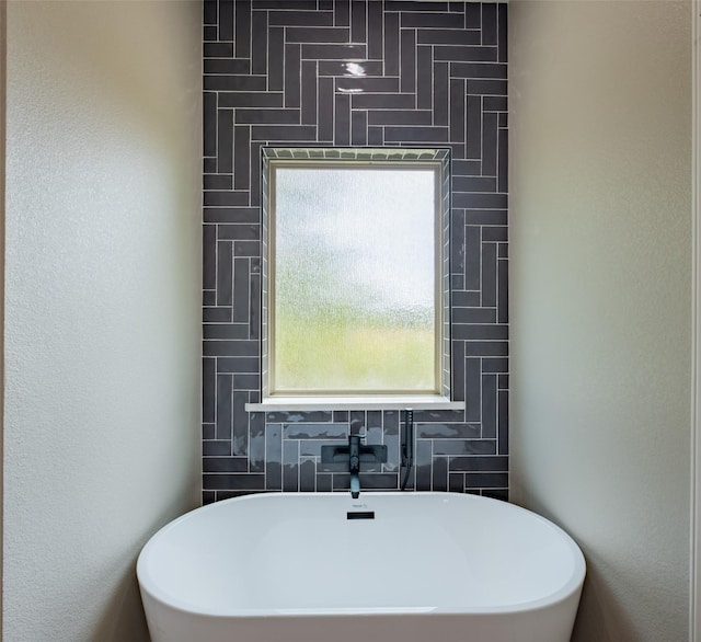 bathroom with a freestanding tub