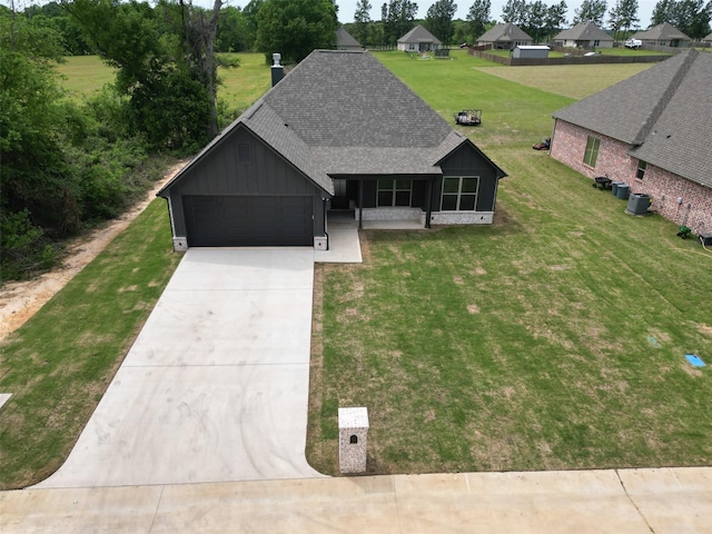 view of front of home featuring concrete driveway, a chimney, board and batten siding, a shingled roof, and a garage