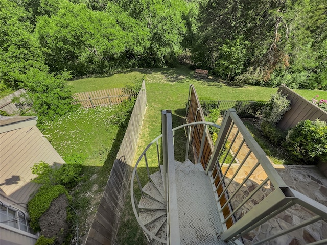 view of property's community featuring a fenced backyard and a yard