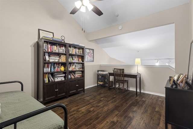 bedroom with baseboards, vaulted ceiling, dark wood-style floors, and track lighting
