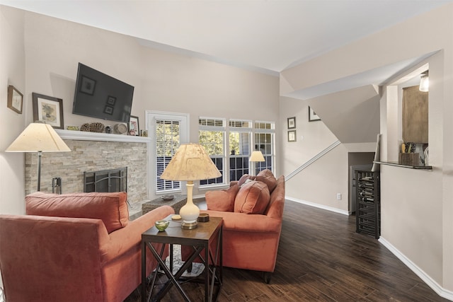 living area with a fireplace, wood finished floors, and baseboards