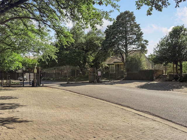 view of street with a gate and a gated entry