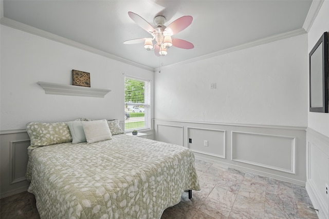 bedroom featuring crown molding, ceiling fan, a decorative wall, and a wainscoted wall