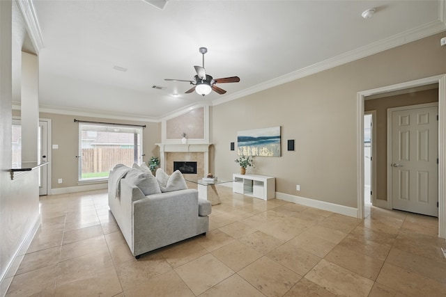 living area featuring baseboards, ornamental molding, ceiling fan, and visible vents
