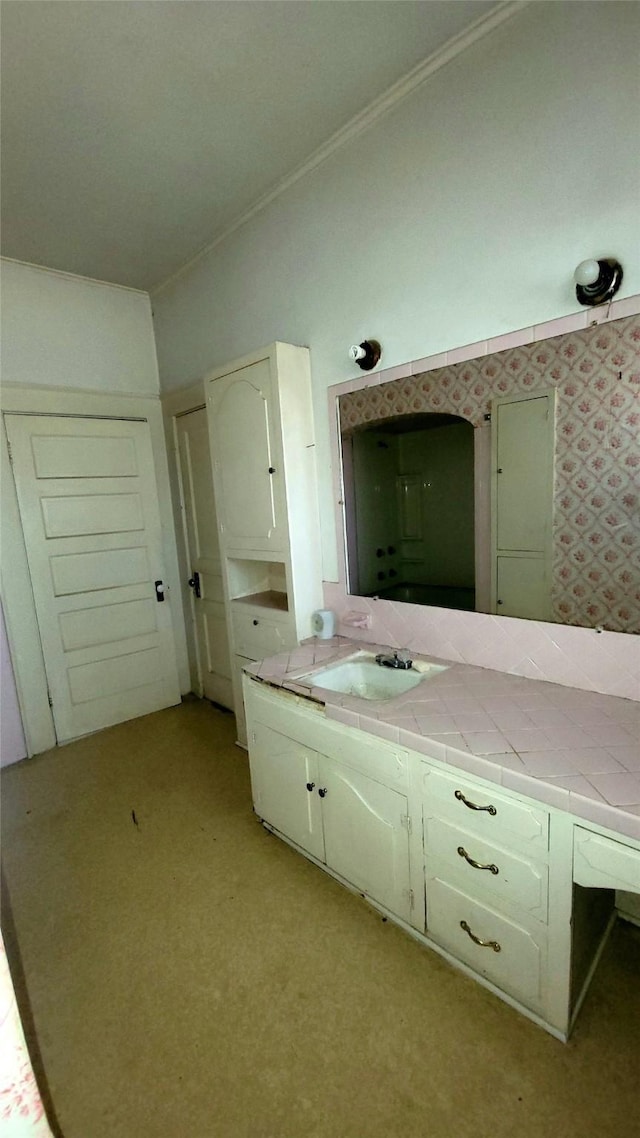 bathroom with vanity and ornamental molding