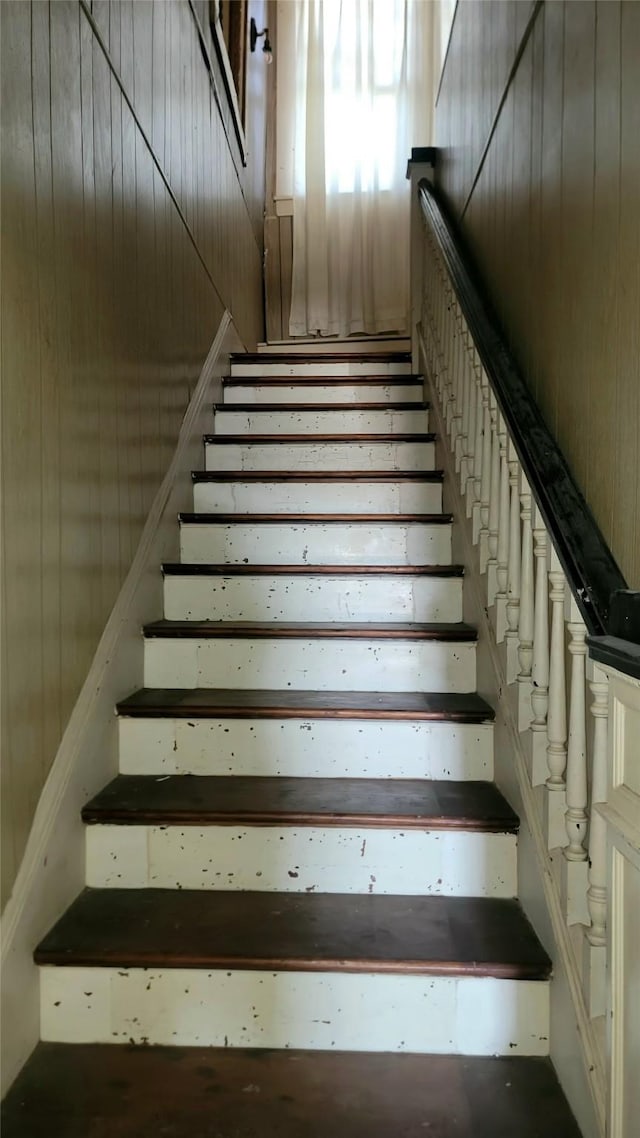 staircase with wooden walls
