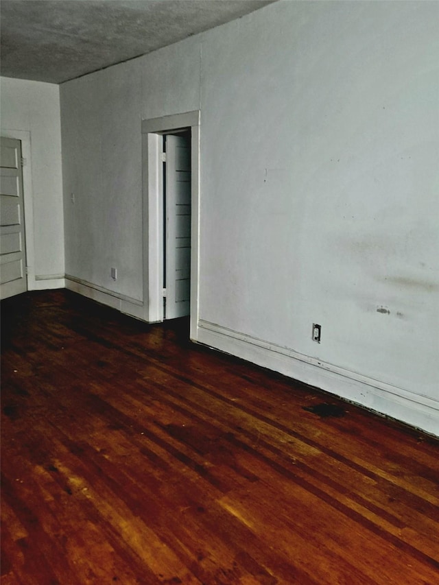 spare room featuring wood finished floors