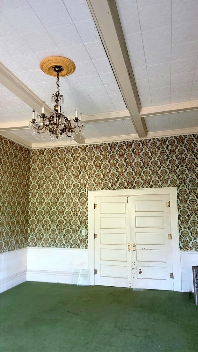 interior space featuring wainscoting, carpet, a notable chandelier, beamed ceiling, and wallpapered walls