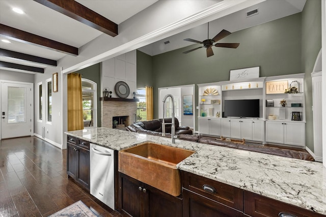 992 Anna Cade Rd, Rockwall, TX 75087 - kitchen with open floor plan, a sink, a ceiling fan, light stone counters, and a fireplace