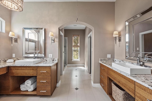 992 Anna Cade Rd, Rockwall, TX 75087 - bathroom with baseboards, tile patterned floors, and two vanities