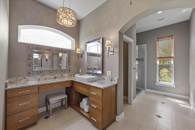 992 Anna Cade Rd, Rockwall, TX 75087 - full bath featuring healthy amount of natural light, a shower stall, vanity, baseboards, and a towering ceiling