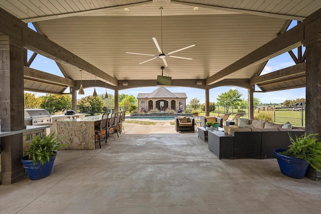 992 Anna Cade Rd, Rockwall, TX 75087 - view of patio featuring an outdoor living space, exterior bar, a grill, fence, and an outdoor kitchen