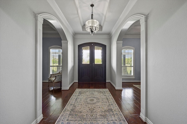 992 Anna Cade Rd, Rockwall, TX 75087 - entryway with arched walkways, dark wood-style floors, a textured wall, and ornamental molding