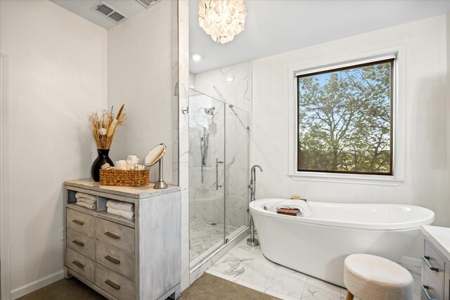195 Lookout Pt, Stephenville, TX 76401 - bathroom featuring marble look tiles, a freestanding tub, a marble finish shower, vanity, and baseboards