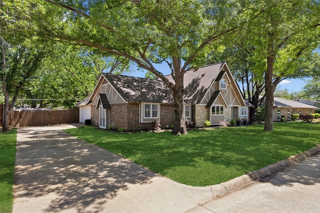 2222 Ravenwood Dr, Grand Prairie, TX 75050 - tudor home with concrete driveway, roof with shingles, stone siding, and brick siding