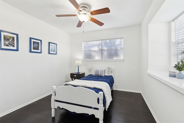 2222 Ravenwood Dr, Grand Prairie, TX 75050 - bedroom with wood finished floors, baseboards, and ceiling fan