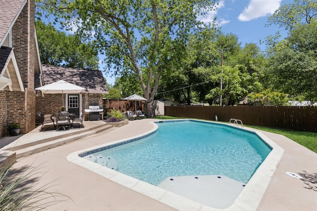 2222 Ravenwood Dr, Grand Prairie, TX 75050 - view of pool featuring a fenced backyard, a patio area, and grilling area
