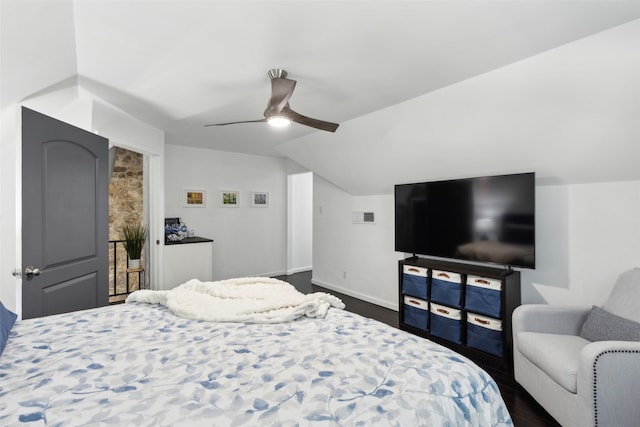 2222 Ravenwood Dr, Grand Prairie, TX 75050 - bedroom featuring dark wood-type flooring, vaulted ceiling, baseboards, and a ceiling fan