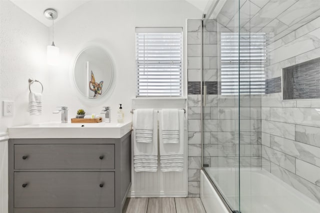 2222 Ravenwood Dr, Grand Prairie, TX 75050 - bathroom featuring vanity, shower / bath combination with glass door, and lofted ceiling