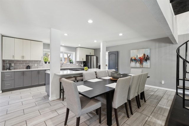 2222 Ravenwood Dr, Grand Prairie, TX 75050 - dining area featuring wood tiled floors, recessed lighting, and baseboards