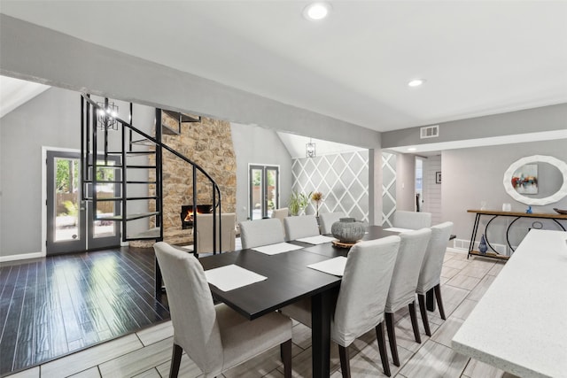 2222 Ravenwood Dr, Grand Prairie, TX 75050 - dining room featuring stairway, healthy amount of natural light, baseboards, vaulted ceiling, and recessed lighting