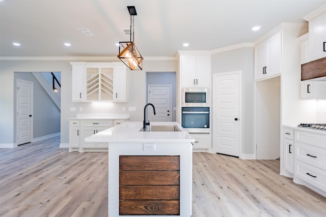 14835 Fallow Ln, Tyler, TX 75706 - kitchen with crown molding, light wood-style flooring, appliances with stainless steel finishes, and a sink