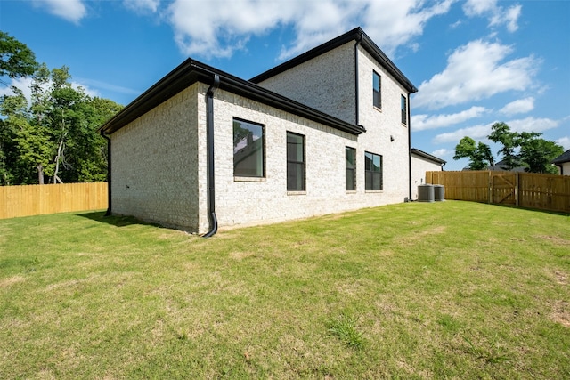 14835 Fallow Ln, Tyler, TX 75706 - back of property with a lawn, a fenced backyard, and central AC unit