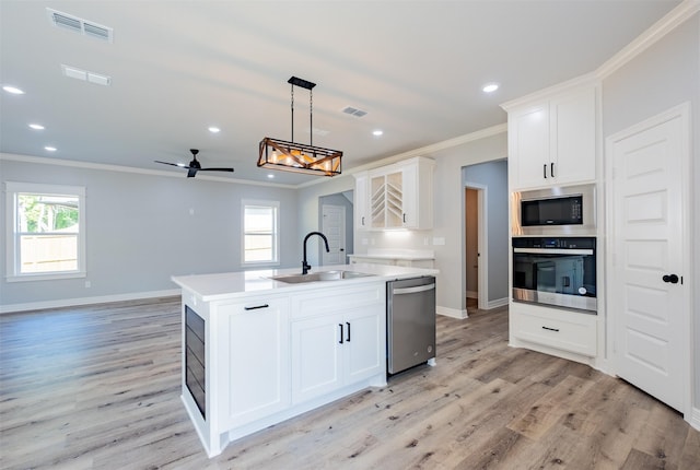 14835 Fallow Ln, Tyler, TX 75706 - kitchen with stainless steel appliances, visible vents, ornamental molding, a sink, and ceiling fan with notable chandelier
