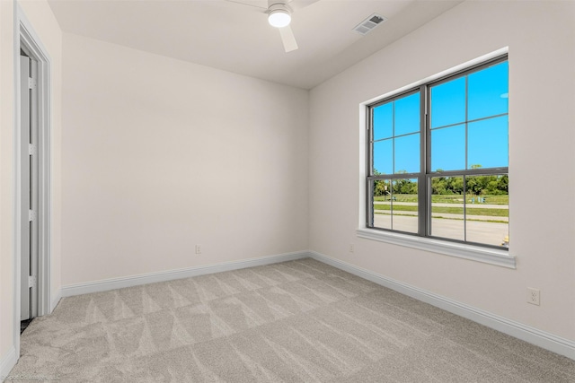unfurnished room with baseboards, a ceiling fan, visible vents, and carpet flooring