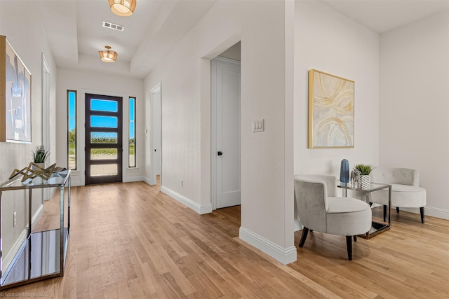 entrance foyer with baseboards, visible vents, and light wood-style flooring