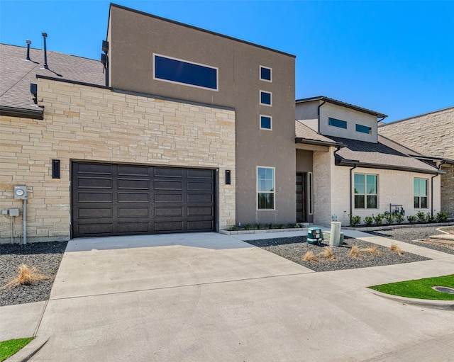 view of front of house with a garage, stucco siding, stone siding, and concrete driveway