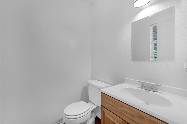 bathroom with toilet and vanity