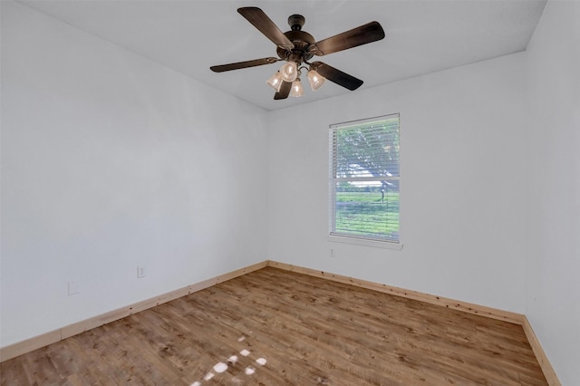 unfurnished room featuring wood finished floors, a ceiling fan, and baseboards