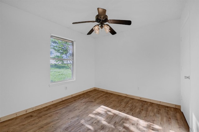 unfurnished room featuring baseboards, a ceiling fan, and wood finished floors