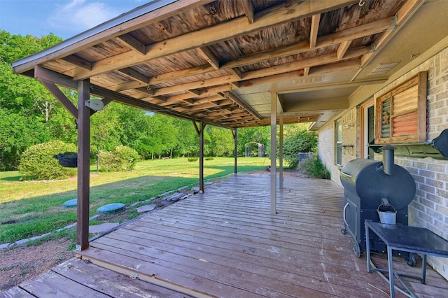 wooden terrace featuring a yard