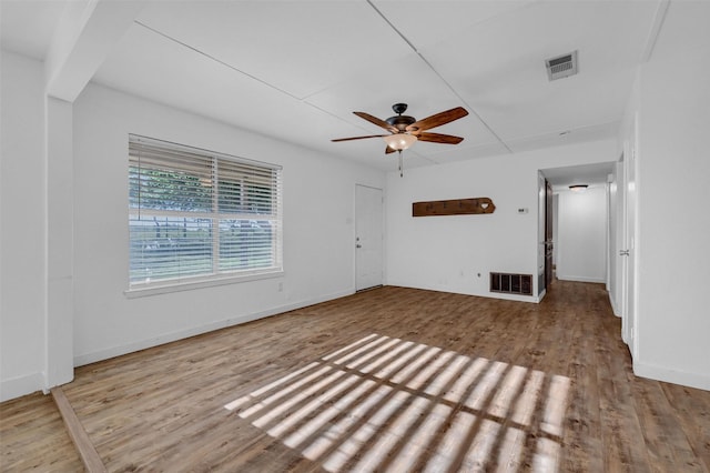 interior space featuring wood finished floors, visible vents, and baseboards