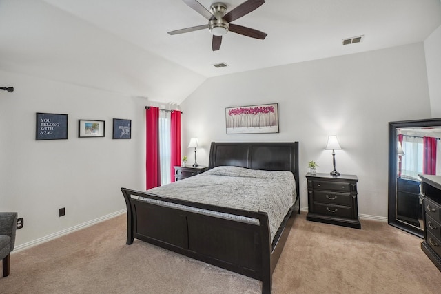 bedroom with visible vents, baseboards, lofted ceiling, and light colored carpet