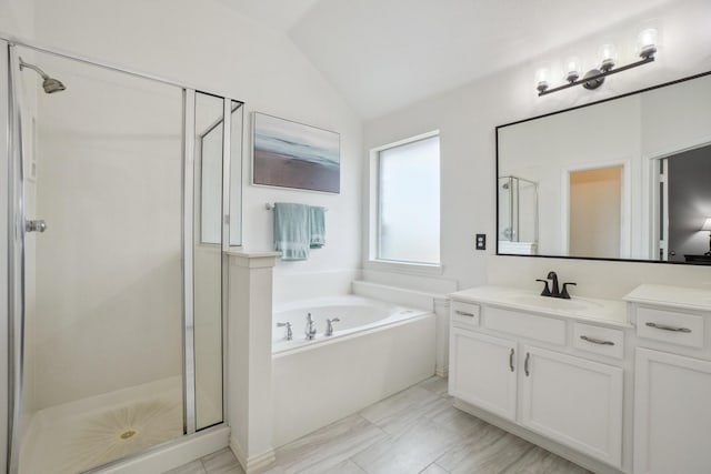 full bath featuring vanity, marble finish floor, lofted ceiling, a bath, and a stall shower