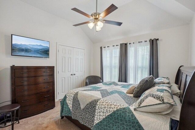 bedroom featuring light colored carpet, ceiling fan, lofted ceiling, and a closet