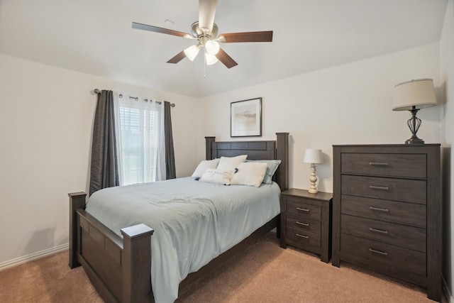 bedroom featuring ceiling fan, light carpet, and baseboards
