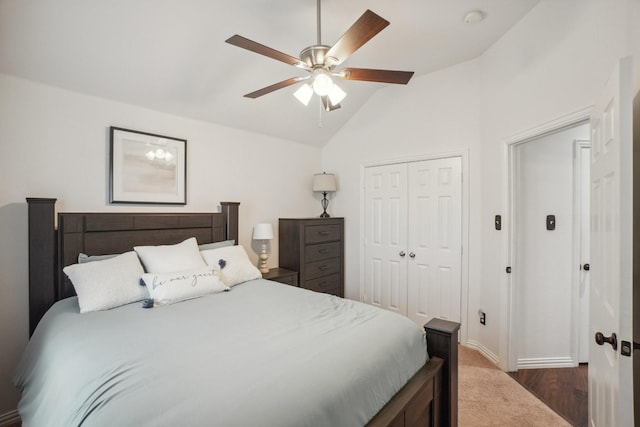 bedroom featuring a ceiling fan, baseboards, lofted ceiling, and a closet