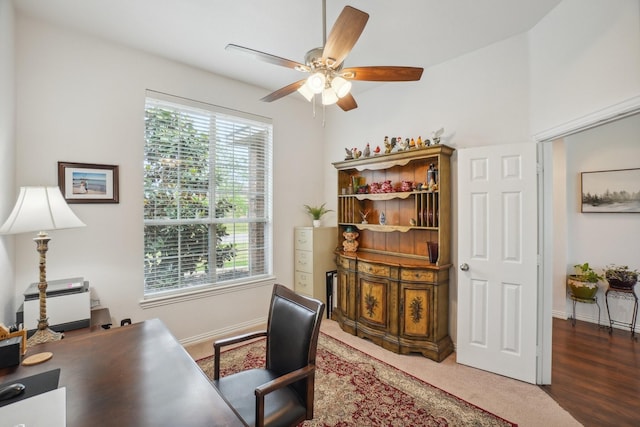 office space with baseboards, ceiling fan, and a wealth of natural light
