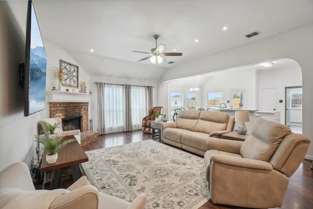 living area featuring visible vents, arched walkways, a ceiling fan, and a wealth of natural light