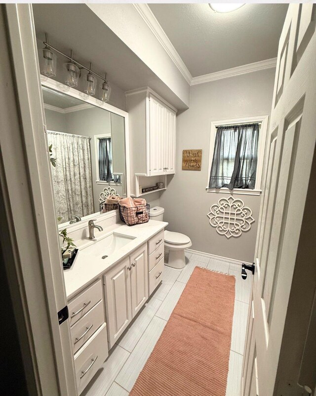 bathroom with crown molding, toilet, a shower with curtain, and vanity