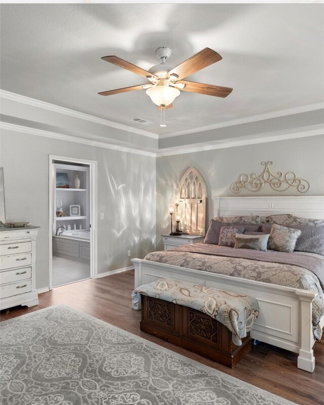 bedroom with visible vents, ornamental molding, and wood finished floors