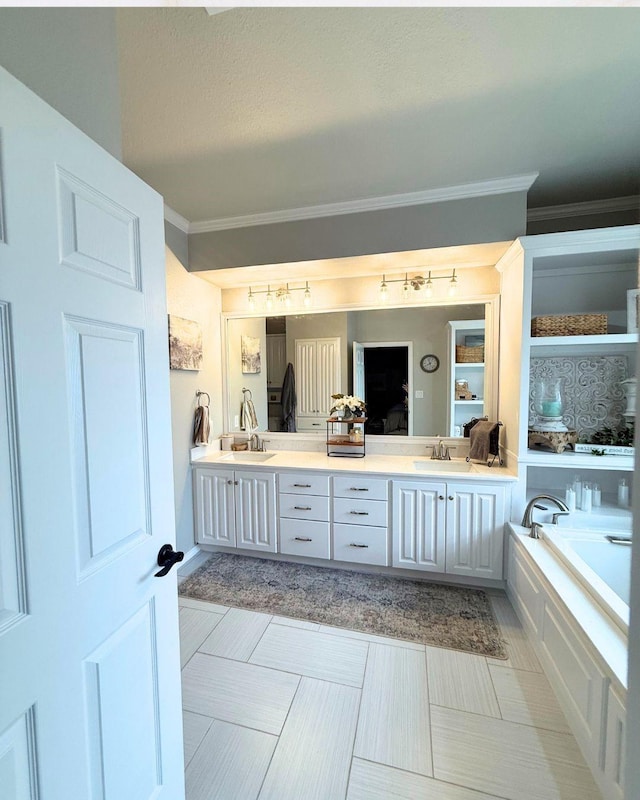 bathroom featuring double vanity, crown molding, a sink, track lighting, and a bathing tub